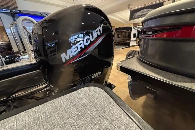 Slide: The Image of 2026 Harris Cruiser 230 with Mercury outboard engine in showroom setting. - 7