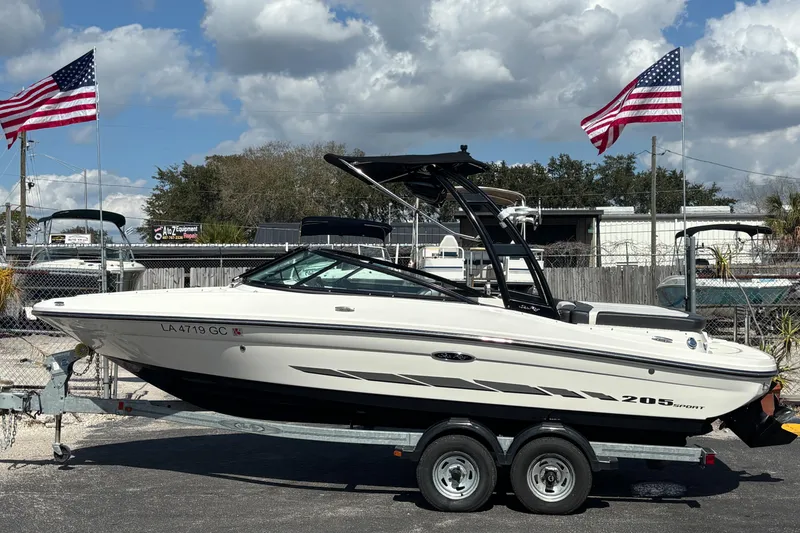 The Image of 2014 Sea Ray 205 Sport boat on trailer, American flags in background. - 0