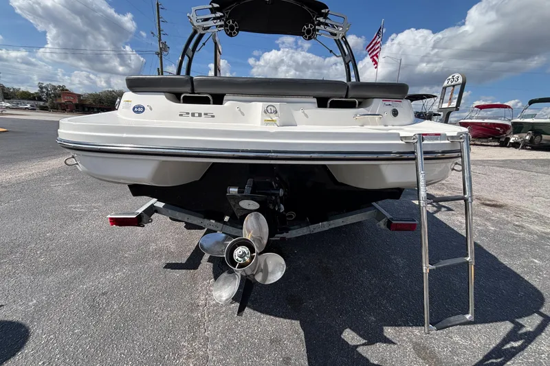 Slide: The Image of 2014 Sea Ray 205 Sport boat rear view with ladder and propeller. - 12