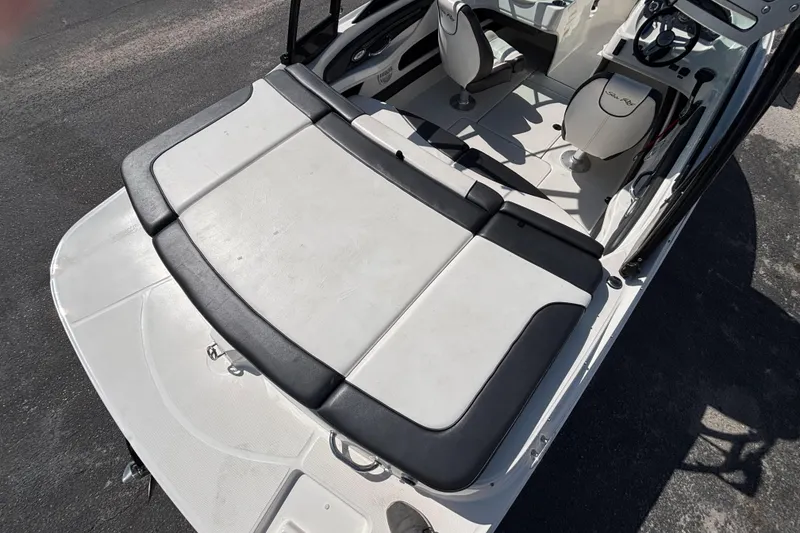 Slide: The Image of 2014 Sea Ray 205 Sport boat interior with cushioned seating and steering wheel. - 14