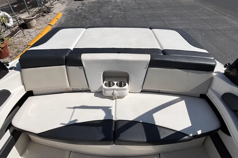 Slide: The Image of 2014 Sea Ray 205 Sport boat interior with cushioned seating and cup holders. - 16