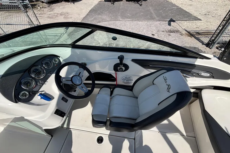 Slide: The Image of 2014 Sea Ray 205 Sport boat interior with steering wheel and dashboard controls. - 17