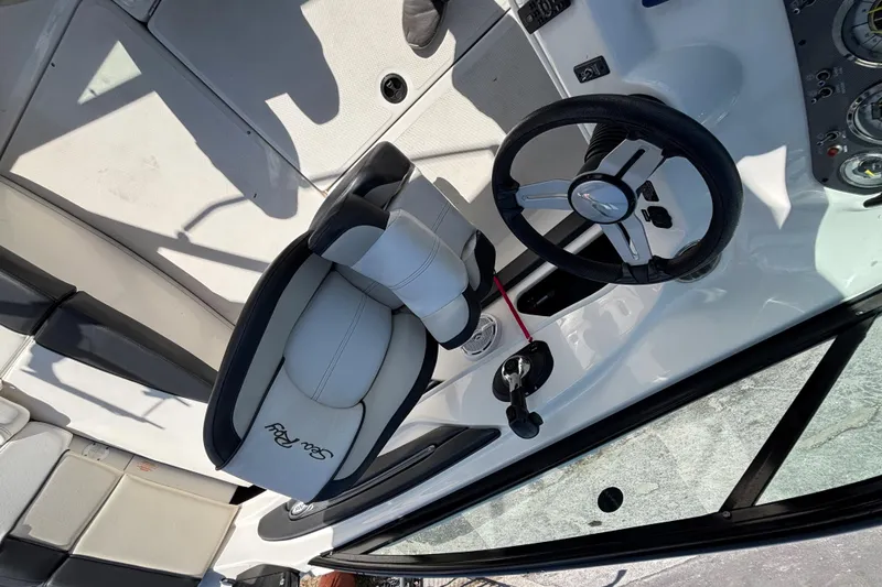 Slide: The Image of 2014 Sea Ray 205 Sport boat interior with steering wheel and seating. - 20