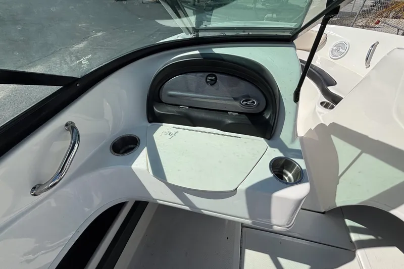Slide: The Image of 2014 Sea Ray 205 Sport boat interior with cup holders and dashboard. - 23