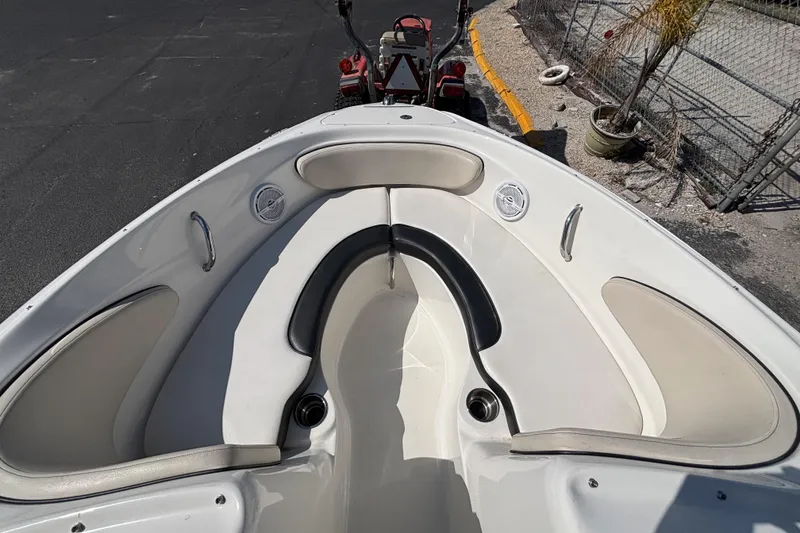 Slide: The Image of 2014 Sea Ray 205 Sport boat interior with cushioned seating and cup holders. - 24