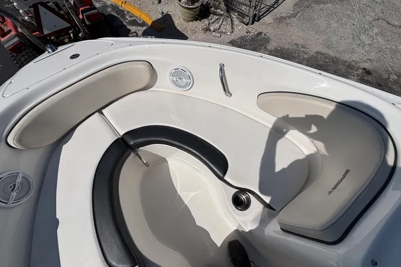 Slide: The Image of Interior of a 2014 Sea Ray 205 Sport boat with white seating and speakers. - 26
