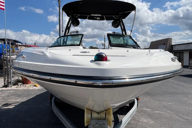Slide: The Image of 2014 Sea Ray 205 Sport boat on trailer under blue sky. - 6