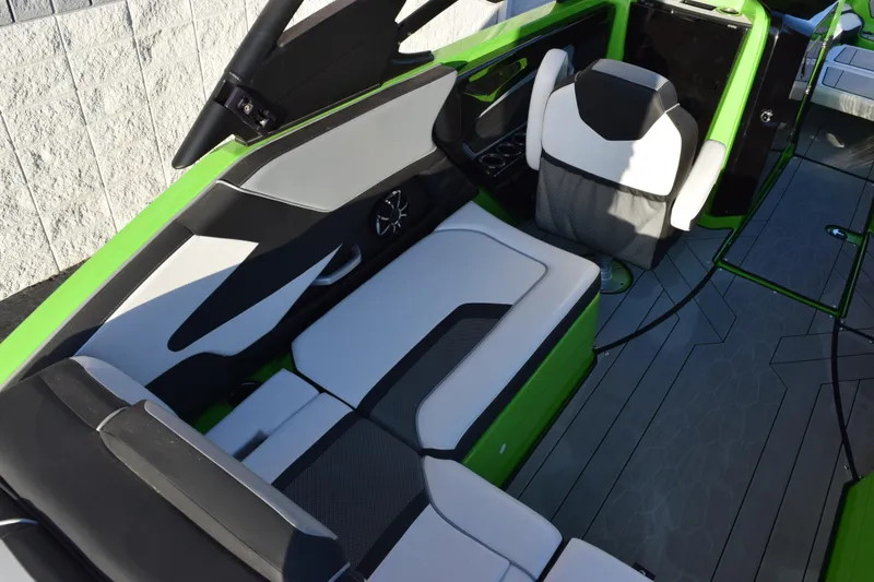Slide: The Image of 2022 Yamaha Boats 255XD interior with green accents and modern seating design. - 11