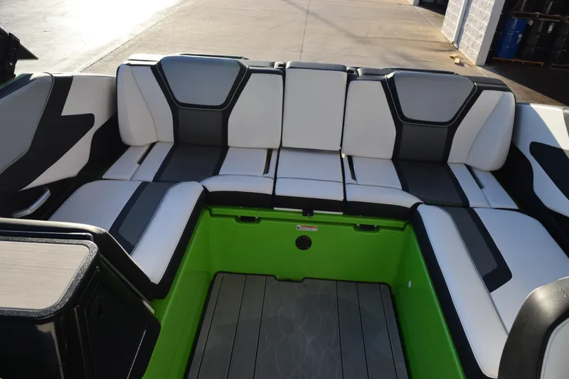 Slide: The Image of 2022 Yamaha Boats 255XD interior with stylish seating and vibrant green accents. - 12