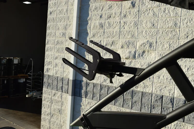 Slide: The Image of Wakeboard rack on 2022 Yamaha Boats 255XD against a textured wall background. - 14