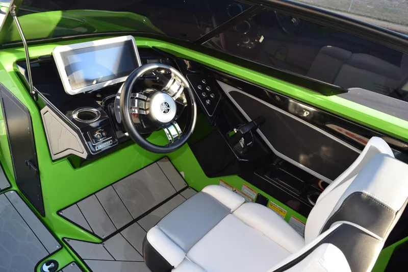 Slide: The Image of 2022 Yamaha Boats 255XD cockpit with green dashboard and modern steering wheel. - 17