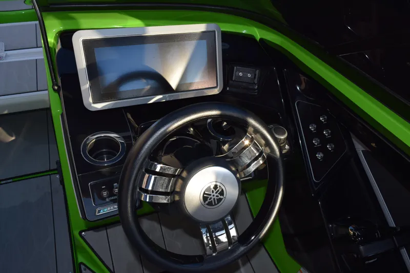 Slide: The Image of 2022 Yamaha Boats 255XD dashboard with steering wheel and touchscreen display. - 18