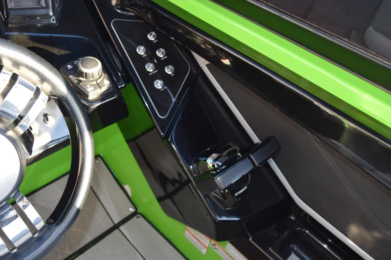 Slide: The Image of Interior view of 2022 Yamaha Boats 255XD, featuring sleek controls and vibrant green accents. - 19