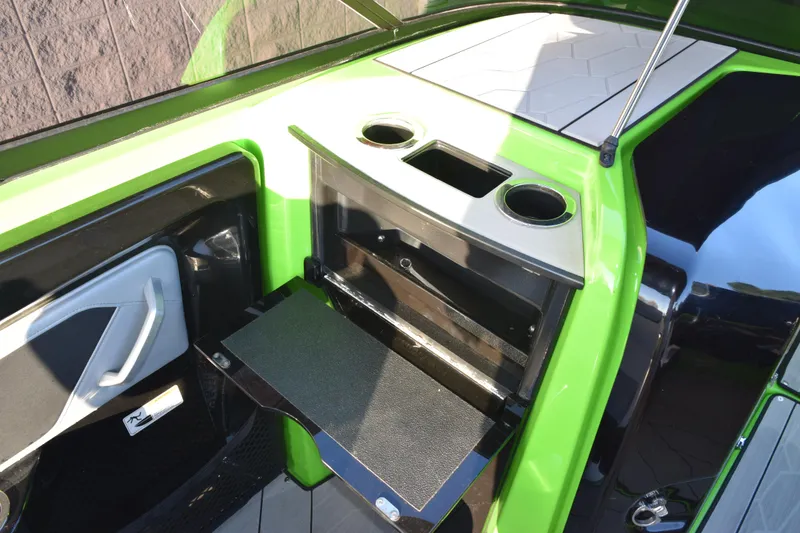 Slide: The Image of 2022 Yamaha Boats 255XD interior with green accents and cup holders. - 22