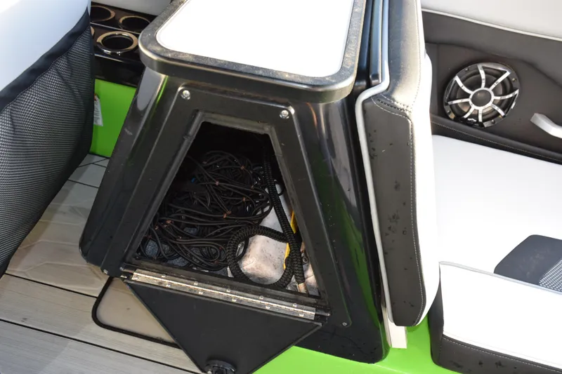 Slide: The Image of Open storage compartment on 2022 Yamaha Boats 255XD, showing ropes and interior details. - 29