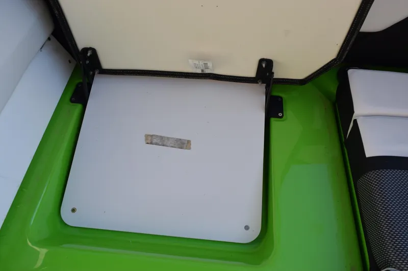 Slide: The Image of 2022 Yamaha Boats 255XD storage compartment with green and white interior. - 30