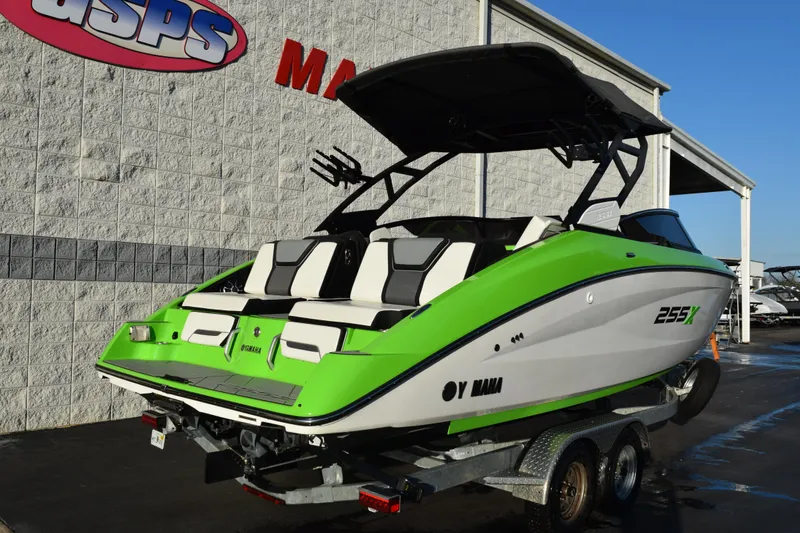 Slide: The Image of 2022 Yamaha Boats 255XD in vibrant green and white on a trailer. - 4