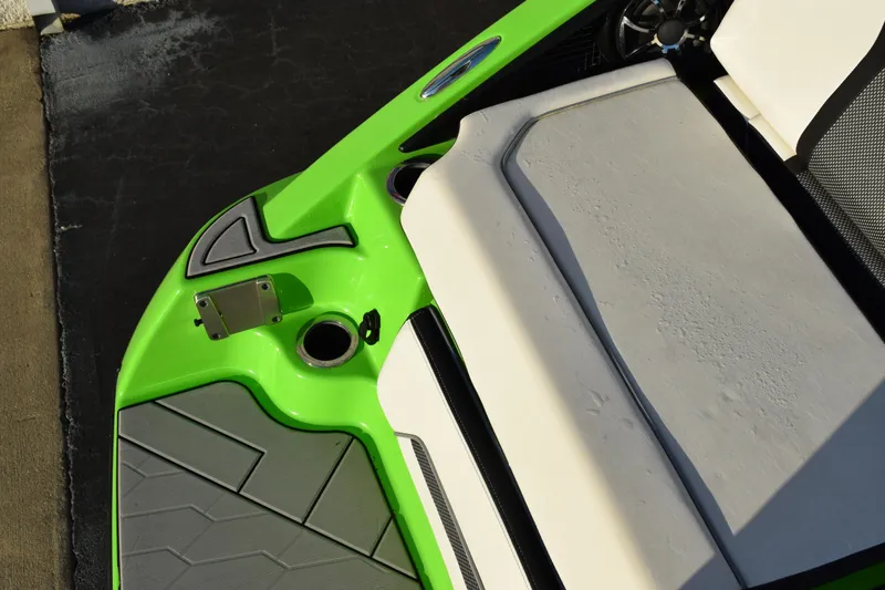 Slide: The Image of 2022 Yamaha Boats 255XD, green and white deck, modern design, close-up view. - 8