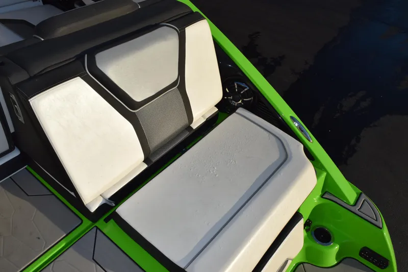 Slide: The Image of 2022 Yamaha Boats 255XD interior with sleek white and black seating, vibrant green accents. - 9