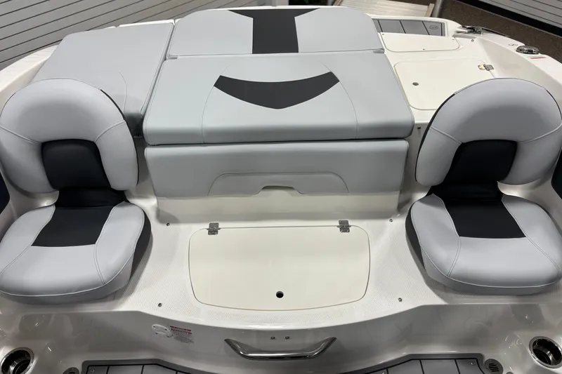 Slide: The Image of 2026 Chaparral 21 SSi Ski & Fish boat interior with gray seating and storage compartments. - 12
