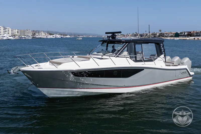 The Image of 2025 Boston Whaler 405 Conquest cruising in a marina, showcasing sleek design and modern features. - 0