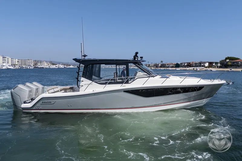 Slide: The Image of 2025 Boston Whaler 405 Conquest boat cruising on a sunny day in a marina. - 12