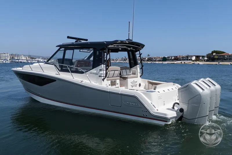 Slide: The Image of 2025 Boston Whaler 405 Conquest boat on water, featuring sleek design and powerful engines. - 13
