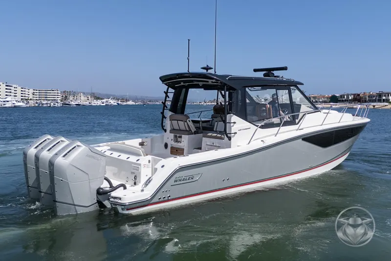 Slide: The Image of 2025 Boston Whaler 405 Conquest boat cruising in a marina, featuring four powerful engines. - 15