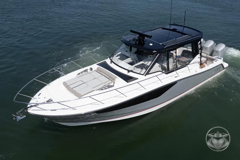 Slide: The Image of 2025 Boston Whaler 405 Conquest cruising on open water, showcasing sleek design and powerful engines. - 16