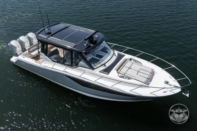 Slide: The Image of 2025 Boston Whaler 405 Conquest boat on water, featuring sleek design and multiple engines. - 17
