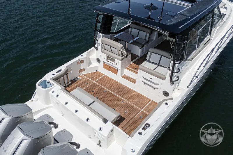 Slide: The Image of 2025 Boston Whaler 405 Conquest boat with spacious deck and seating on water. - 2