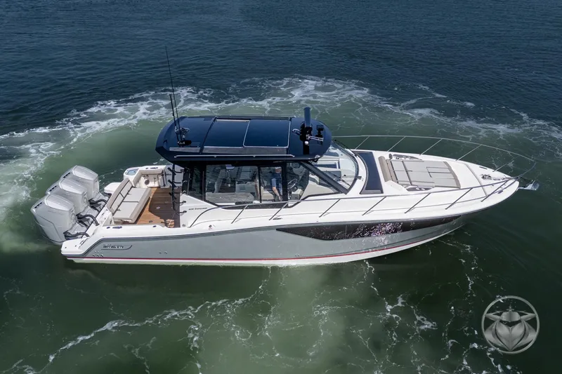 Slide: The Image of 2025 Boston Whaler 405 Conquest cruising on open water, showcasing sleek design and powerful engines. - 21