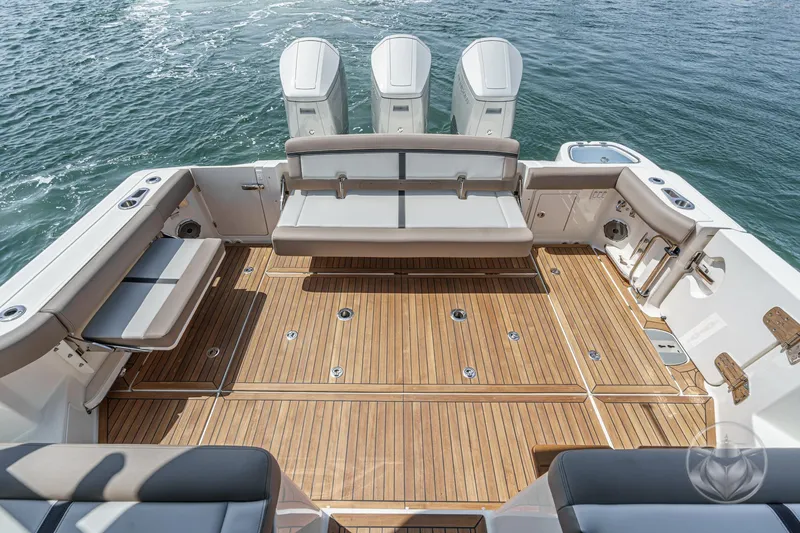 Slide: The Image of 2025 Boston Whaler 405 Conquest boat deck with seating and outboard motors. - 28