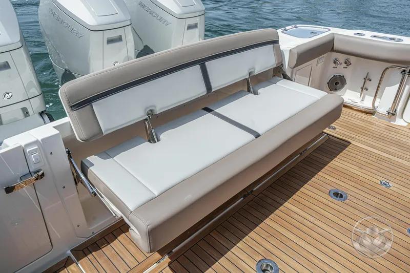 Slide: The Image of 2025 Boston Whaler 405 Conquest boat with cushioned seating and Mercury engines. - 30