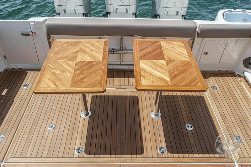 Slide: The Image of Teak deck with dual tables on 2025 Boston Whaler 405 Conquest boat. - 33