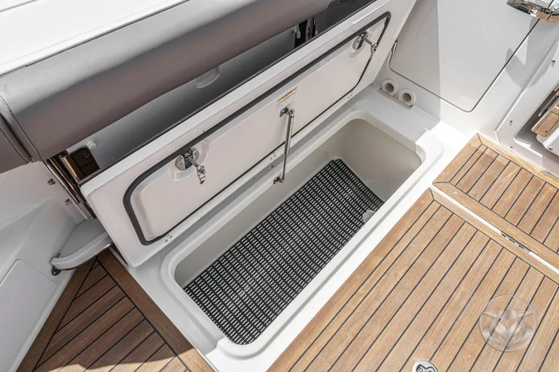 Slide: The Image of 2025 Boston Whaler 405 Conquest storage compartment with teak flooring and secure latch. - 38