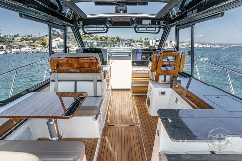 Slide: The Image of 2025 Boston Whaler 405 Conquest interior with luxurious seating and modern navigation equipment. - 4
