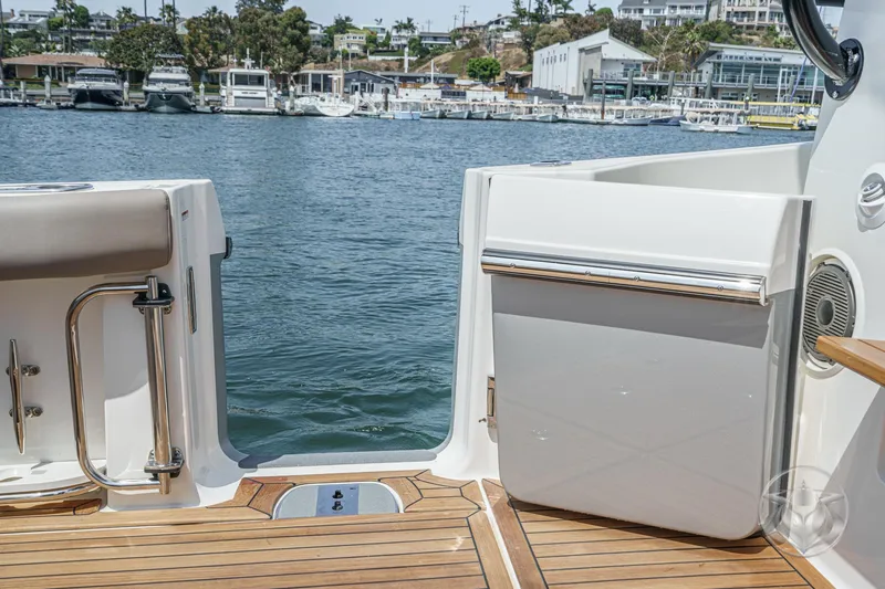 Slide: The Image of Boston Whaler 405 Conquest 2025 boat deck with water view and marina background. - 40