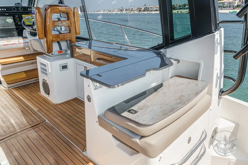 Slide: The Image of 2025 Boston Whaler 405 Conquest interior with sleek design, wooden accents, and ocean view. - 46