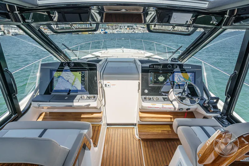 Slide: The Image of 2025 Boston Whaler 405 Conquest helm with advanced navigation systems and luxurious seating. - 5