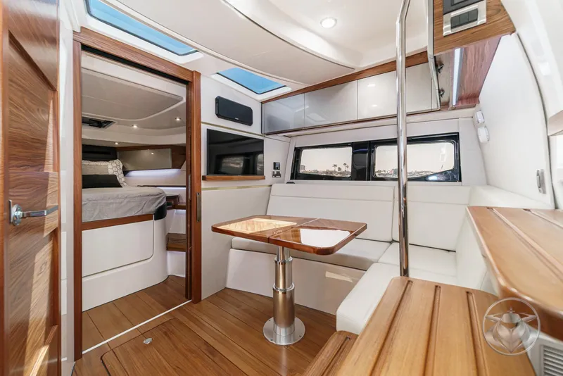 Slide: The Image of Luxurious interior of 2025 Boston Whaler 405 Conquest yacht with modern seating and wood finishes. - 6
