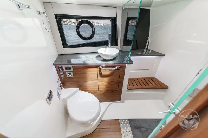 Slide: The Image of Luxurious bathroom interior of 2025 Boston Whaler 405 Conquest yacht, featuring modern fixtures and wood accents. - 7