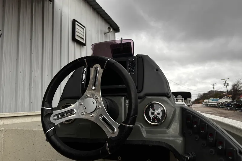 Slide: The Image of 2021 Xpress X18PFC boat on trailer, side view with logo visible. - 13