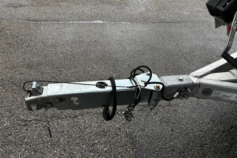 Slide: The Image of 2021 Xpress X18PFC trailer wheel with black tire and silver rim on gravel. - 16