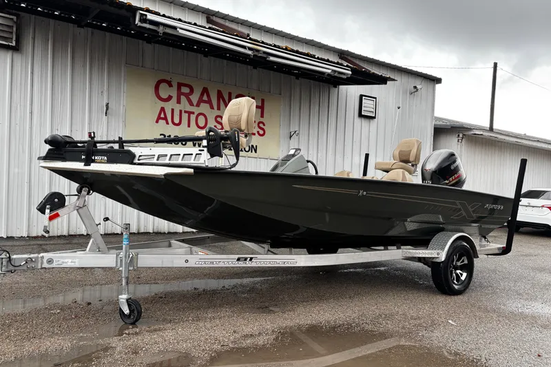Slide: The Image of 2021 Xpress X18PFC boat with Yamaha outboard motor on a trailer. - 18