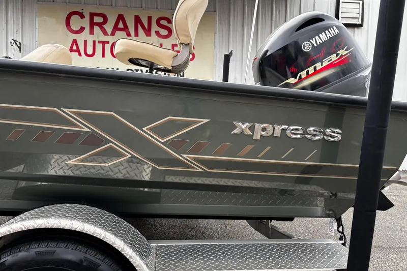 Slide: The Image of 2021 Xpress X18PFC boat with 115 HP engine, parked on a trailer. - 20