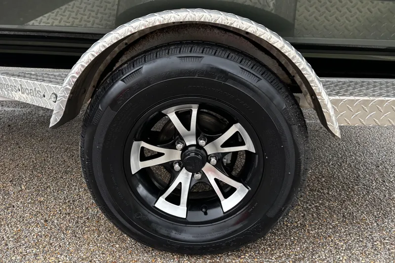 Slide: The Image of 2021 Xpress X18PFC boat with Yamaha outboard motor on trailer, parked outdoors. - 21