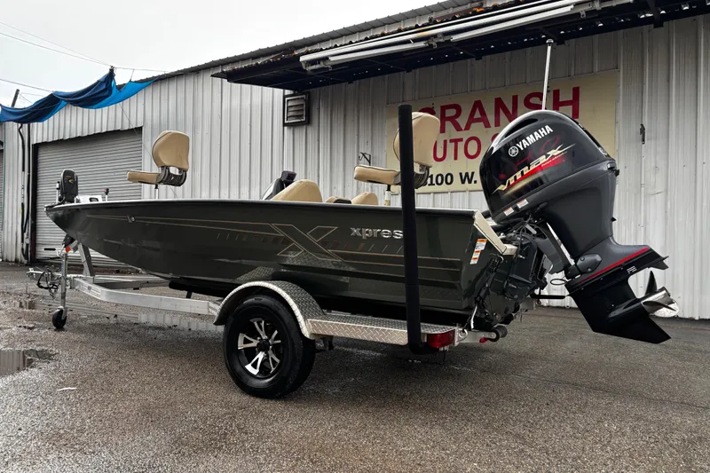 Slide: The Image of 2021 Xpress X18PFC boat on trailer, showing rear hull and mounting details. - 23