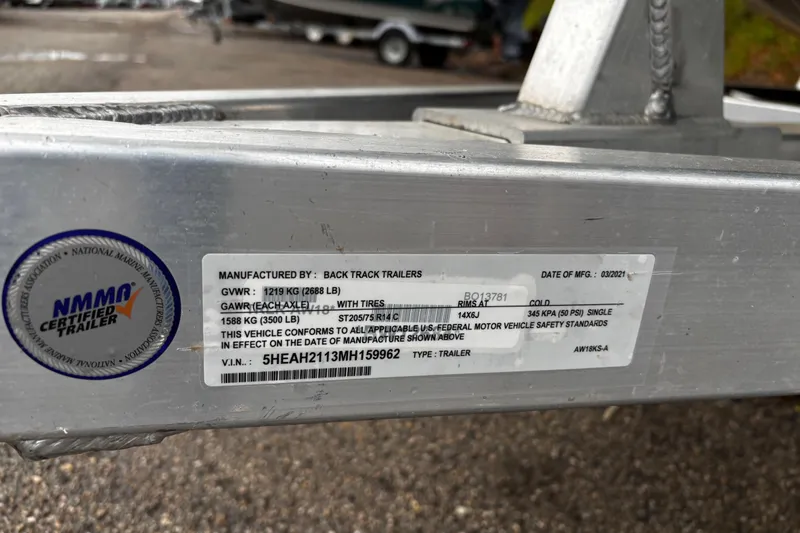 Slide: The Image of 2021 Xpress X18PFC boat engine and wiring detail on speckled deck. - 28