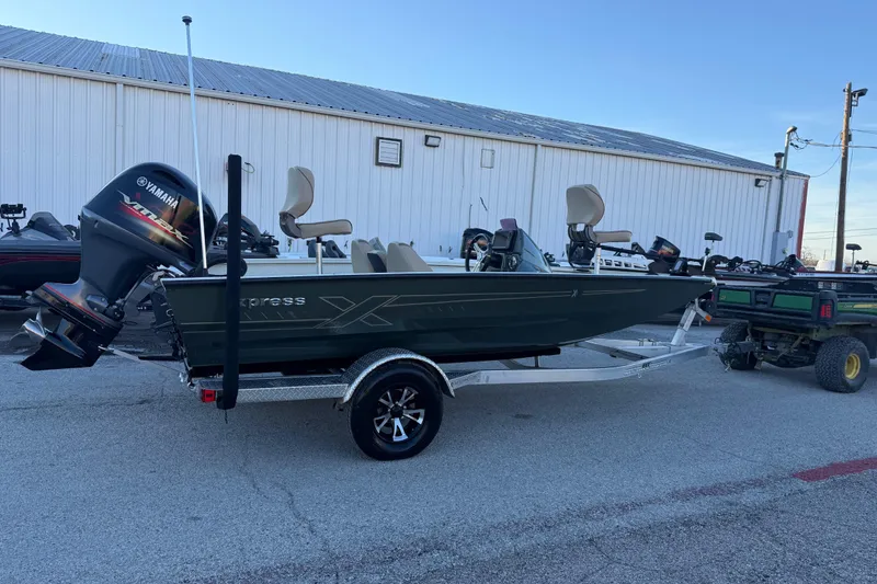 Slide: The Image of 2021 Xpress X18PFC boat with Yamaha engine on trailer, parked outdoors. - 31